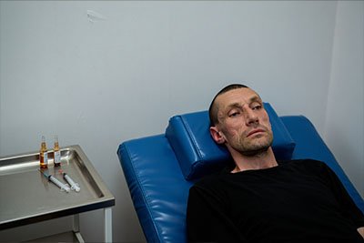 Кодирование Мужчина лежит на кушетки и готовится к кодированию
